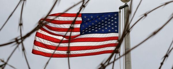 An American Flag is seen through razor wire at Camp VI in Camp Delta where detainees are housed at Naval Station Guantanamo Bay in Cuba An American Flag is seen through razor wire at Camp VI in Camp Delta where detainees are housed at Naval Station Guantanamo Bay in Cuba - Sputnik Moldova