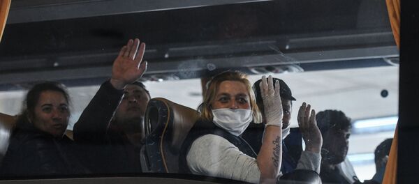 Сезонные рабочие из Румынии машут из автобуса по пути к фермеру после прибытия в аэропорт Дюссельдорфа - Sputnik Moldova-România