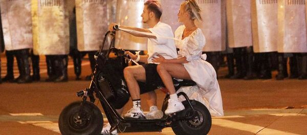 Cuplu pe un scuter în fața polițiștilor în timpul protestelor din Minsk - Sputnik Moldova