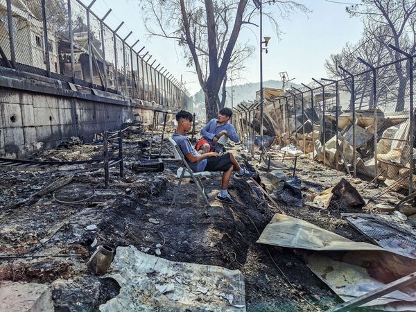 Мигранты в сгоревшем лагере Мория на острове Лесбос - Sputnik Moldova-România