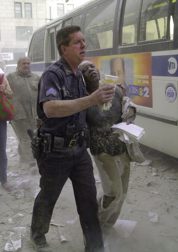 Офицер полиции с пострадавшей во время теракта 11 сентября, США  - Sputnik Молдова