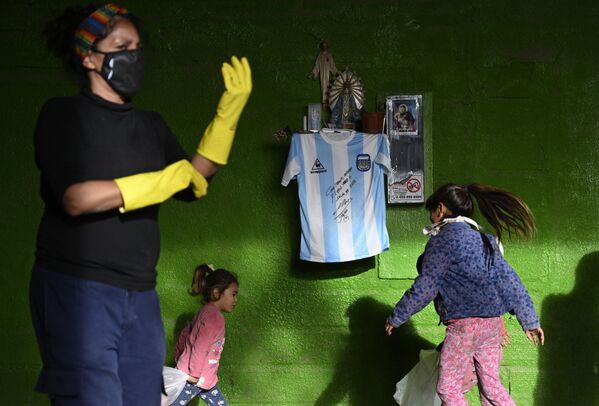 Копия футболки сборной Аргентины по футболу с подписью Диего Марадоны на стене дома  - Sputnik Молдова