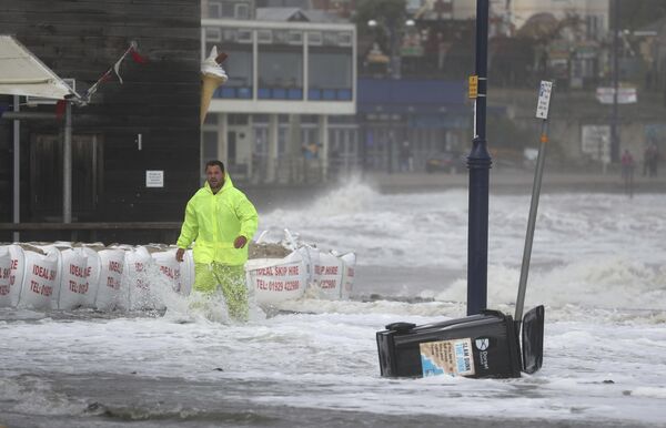 Мужчина на затопленной набережной города Суонедж, Великобритания  - Sputnik Moldova-România