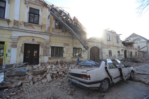 Destroyed houses and a car are seen on a street after an earthquake in Petrinja, Croatia December 29, 2020.  - Sputnik Молдова