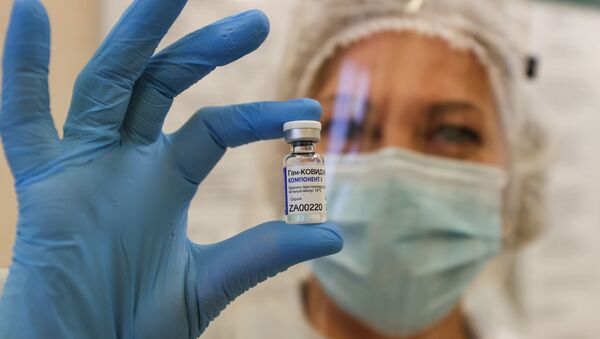 Медицинский работник демонстрирует флакон с вакциной Sputnik V (Gam-COVID-Vac) во время вакцинации против коронавирусной болезни (COVID-19) - Sputnik Moldova-România