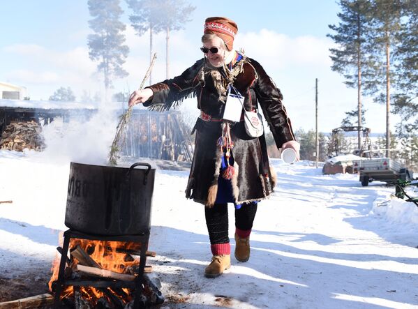 Практикующий нойд (шаман) и хранитель традиционных знаний народа саами Надя Фенина варит уху на празднике Мистический север - Sputnik Молдова