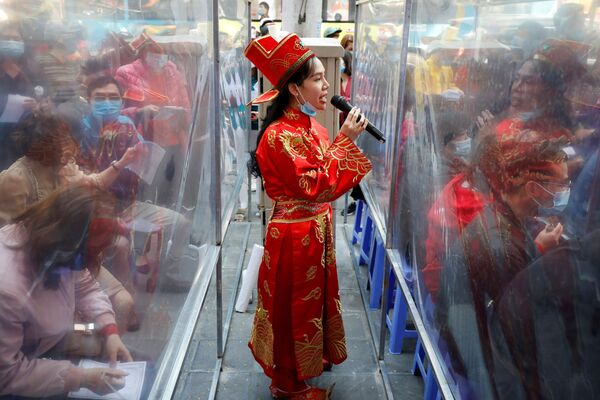 Девушка-сотрудница магазина по продаже золотых украшений, одетая в костюм бога богатства в Ханое, Вьетнам. - Sputnik Молдова