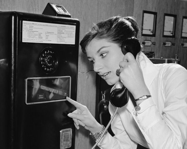 Немецкая девушка во время использования телефона с междугородной связью, 1957 год  - Sputnik Moldova-România