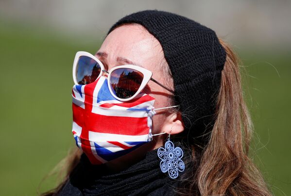 Женщина в маске у Виндзорского замка во время похорон британского принца Филиппа - Sputnik Молдова