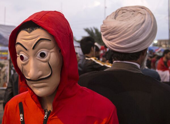 Иракский протестующий в красном комбинезоне и маске Дали - Sputnik Moldova-România