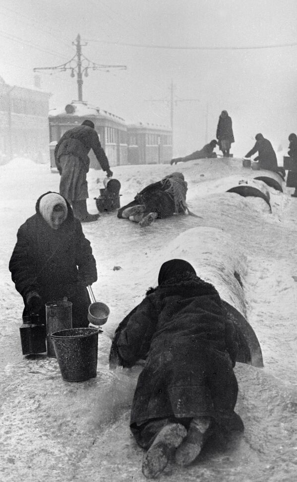 Locuitorii din Leningradul asediat colectează apă dintr-o conductă de apă spartă pe o stradă înghețată. - Sputnik Moldova-România