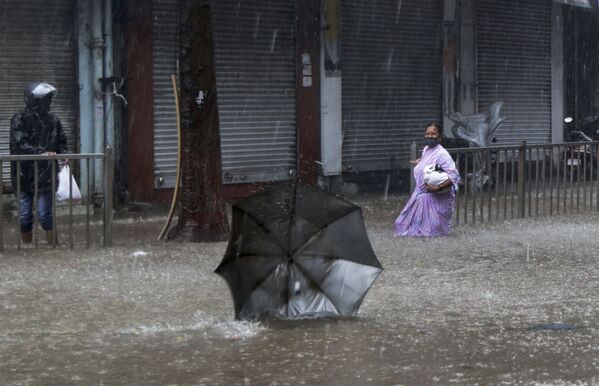 Женщина на затопленной улице во время циклона в Мумбаи  - Sputnik Молдова