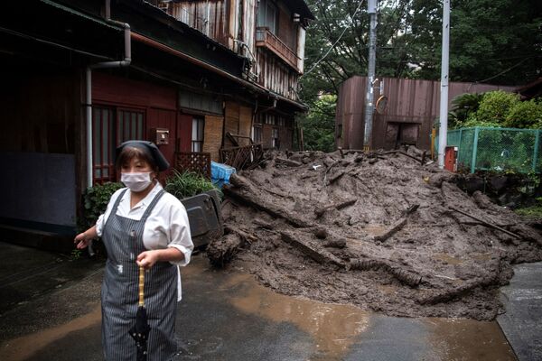 A resident stands near mud and debris at the scene of a landslide following days of heavy rain in Atami in Shizuoka Prefecture on July 3, 2021. - Sputnik Молдова