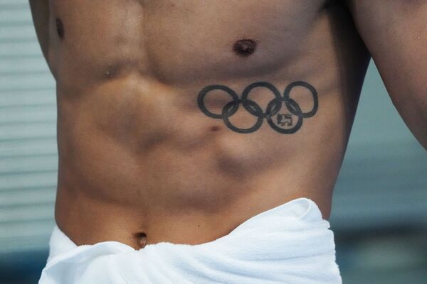 Пловец гуляет по террасе у бассейна перед соревнованиями в Аквацентре Токио на летних Олимпийских играх 2020-го. - Sputnik Молдова