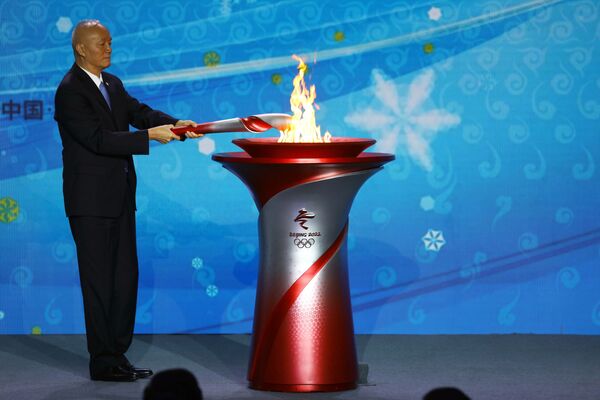 Secretarul Partidului Comunist din Beijing, președintele Comitetului de organizare Beijing 2022, Cai Qi, transferă flacăra olimpică la ceremonia de la Beijing. - Sputnik Moldova