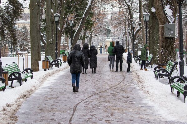 Жители города гуляют по заснеженным аллеям. - Sputnik Молдова