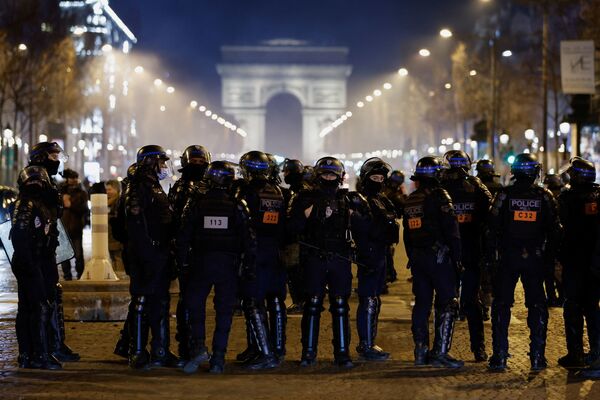 Ofițerii de poliție sunt văzuți pe bulevardul Champs-Elysees în timp ce mașinile încearcă să blocheze traficul în timpul „Convoi de la liberte” (Convoiul Libertății), un convoi de vehicule pentru a protesta împotriva vaccinului împotriva coronavirusului (COVID-19) și a restricțiilor din Paris, Franța. , 12 februarie 2022. - Sputnik Moldova-România