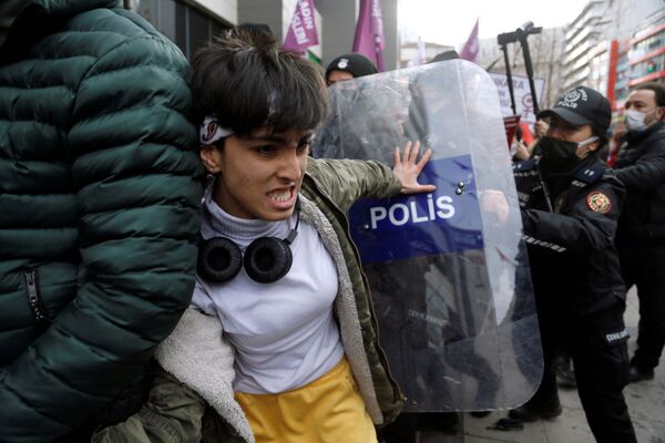 Демонстрант дерется с ОМОНом во время митинга в преддверии Международного женского дня в Анкаре, Турция, 6 марта 2022 года. - Sputnik Молдова
