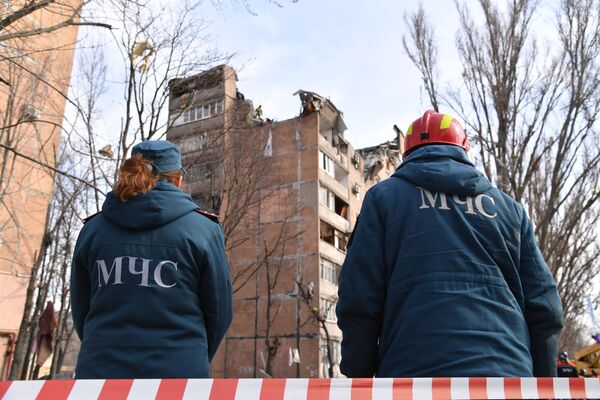 Angajații Ministerului Situațiilor de Urgență din RPD lângă clădirea rezidențială avariată de pe strada Pintera din Donețk. - Sputnik Moldova-România