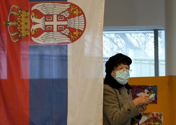 O femeie care poartă o mască de protecție împotriva coronavirusului, se pregătește să voteze la o secție de votare din Belgrad, Serbia, duminică, 3 aprilie 2022. - Sputnik Moldova-România
