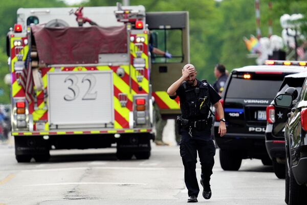 Un ofițer de poliție reacționează în timp ce se plimbă în centrul orașului Highland Park, după un atac armat de Ziua Independenței, în Chicago - Sputnik Moldova