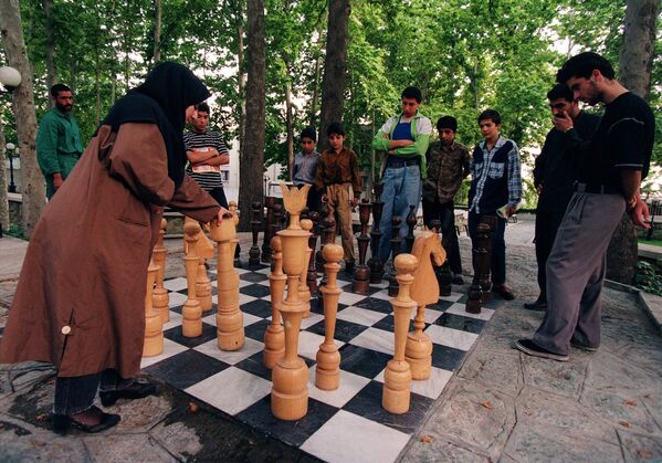 O fată iraniană joacă șah pe o tablă mare într-un parc public în Teheran, 25 mai 1997. - Sputnik Moldova-România