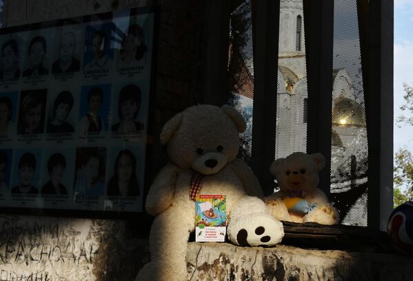 O jucărie și fotografii ale victimelor atacului terorist de la școala nr. 1 din Beslan. Pe data de 1 septembrie 2004, în orașul Beslan din Republica Osetia de Nord-Alania, un grup de teroriști a capturat clădirea școlii gimnaziale nr.1. Victimele acțiunii teroriste au devenit 334 de persoane, inclusiv 318 ostatici, dintre care 186 copii. - Sputnik Moldova-România