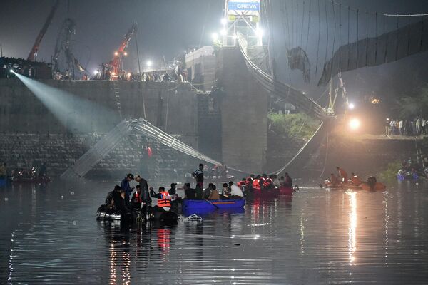 Индийские спасатели проводят поисковые операции после обрушения моста через реку Маччху в Морб - Sputnik Молдова