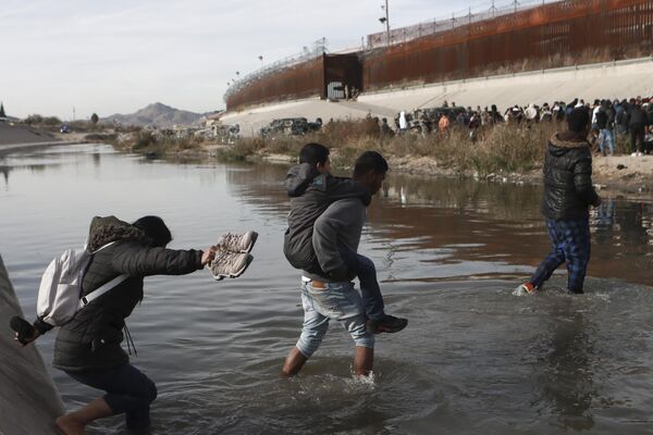 Мигранты пересекают Рио-Гранде в направлении американо-мексиканской границы в Сьюдад-Хуаресе, Мексика. - Sputnik Молдова