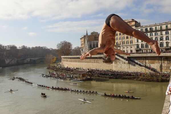 Марко Фойс из Италии ныряет в реку Тибр с 18-метрового моста Кавур в честь Нового года в Риме. - Sputnik Молдова