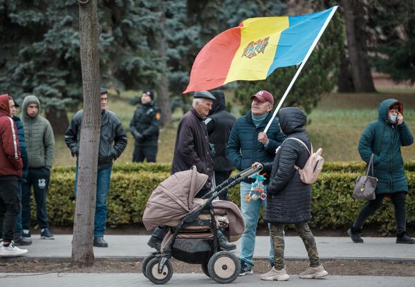 Женщина с детской коляской беседует с одним из участников протеста в Кишиневе перед зданием парламента. - Sputnik Молдова