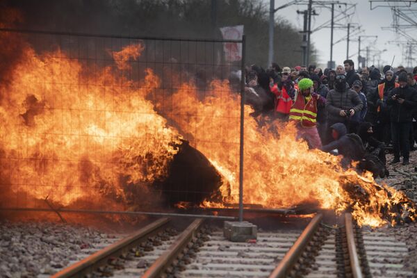 Protestatarii în timpul unei demonstrații au dat foc unei baricade instalate pe calea ferată din apropierea unei gări  - Sputnik Moldova-România