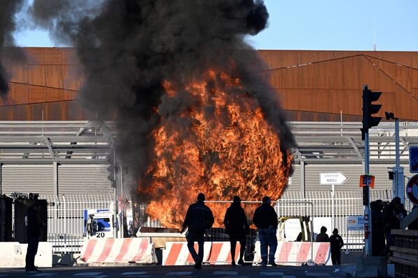 Unioniștii stau în fața unui incendiu în timpul blocadei portului Marsilia (Port Autonome de Marseille), sudul Franței - Sputnik Moldova-România