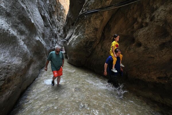 Люди прячутся от жары в тени каньона Tangeh Vashi в Иране. - Sputnik Молдова
