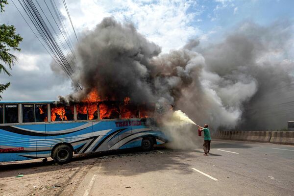 Активисты Националистической партии Бангладеш подожгли автобус во время протеста с требованием отставки премьер-министра Шейха Хасины, Бангладеш. - Sputnik Молдова