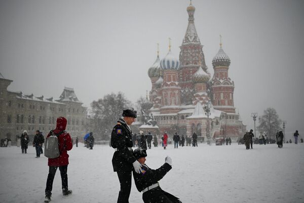 Российские кадеты делают селфи перед собором Василия Блаженного на заснеженной Красной площади в Москве. - Sputnik Молдова