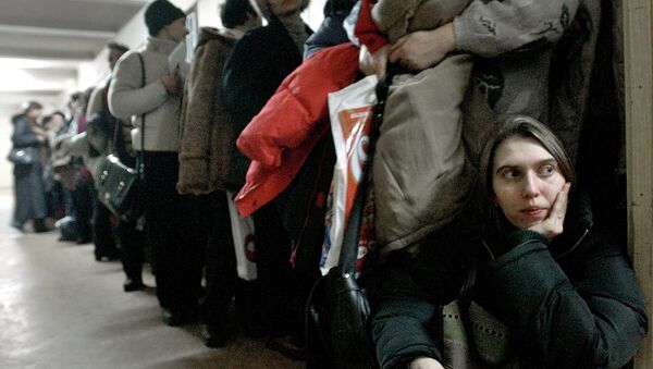 In this image dated Jan.28, 2004, showing a Romanian woman as she leans against the door at the International Office for Migration in Bucharest, Romania, Jan. 28, 2004, waiting in a line to apply for a job in Spain - Sputnik Молдова