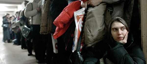 In this image dated Jan.28, 2004, showing a Romanian woman as she leans against the door at the International Office for Migration in Bucharest, Romania, Jan. 28, 2004, waiting in a line to apply for a job in Spain - Sputnik Moldova-România