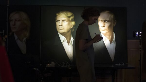 A journalist writes a material as she watches a live telecast of the U.S. presidential election standing at portraits of U.S. presidential candidate Donald Trump and Russian President Vladimir Putin in the Union Jack pub in Moscow, Russia, Wednesday, Nov. 9, 2016 - Sputnik Moldova