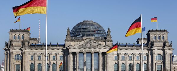 German flags wave in front of the Reichstag building, host of the German Federal Parliament Bundestag, in Berlin, Germany. (File) - Sputnik Moldova