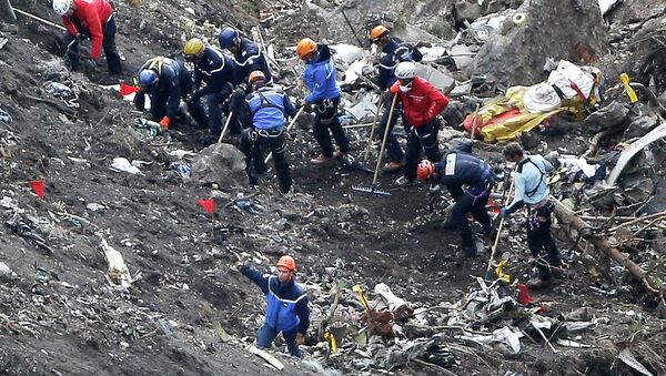 In this March 26, 2015 file photo, rescue workers work on debris of the Germanwings jet at the crash site near Seyne-les-Alpes, France - Sputnik Moldova-România