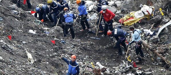 In this March 26, 2015 file photo, rescue workers work on debris of the Germanwings jet at the crash site near Seyne-les-Alpes, France - Sputnik Moldova-România