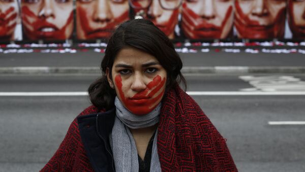 A member of the NGO Rio de Paz poses during an exhibit demonstration against violence against women, displaying some 420 panties and portraits of bloodstained women, in Paulista Avenue in Sao Paulo, Brazil on June 10, 2016. - Sputnik Moldova-România