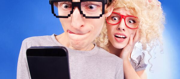 Молодой человек и девушка со смартфоном - Sputnik Moldova