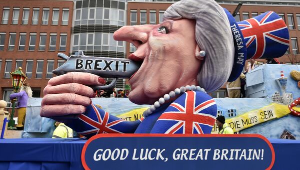 A carnival float depicts British Prime Minister Theresa May with a gun and the writing 'Brexit' on it prior to the traditional carnival parade in Duesseldorf, Germany, on Monday, Feb. 27, 2017.  - Sputnik Moldova-România