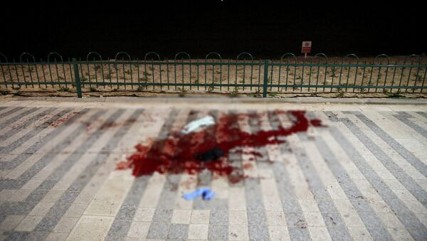 Blood stain can be seen on the promenade by the Mediterranean shore where, according to Israeli police spokesperson, at least 10 Israelis were stabbed, in the popular Jaffa port area of Tel Aviv, Israel - Sputnik Молдова