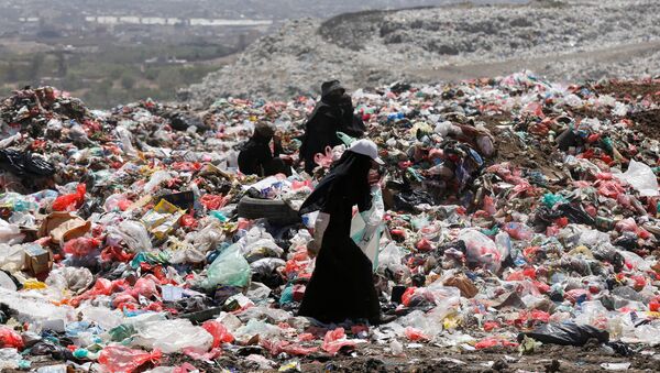 Женщина собирает вещи и предметы, годные для дальнейшего использования, на мусорной свалке на окраине Саны, Йемен - Sputnik Молдова