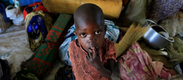 Мальчик-беженец из Южного Судана, который вместе со своей семьей бежал из города Пайок от продолжающихся в их стране боевых действий, разрушений и голода, на территорию Уганды. На фото - мальчик стоит рядом с вещами своей семьи в лагере в Ламво на севере Уганды - Sputnik Moldova