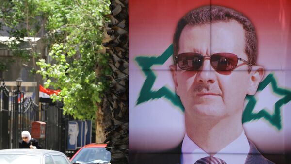 Poster bearing a portrait of President Bashar al-Assad - Sputnik Moldova-România