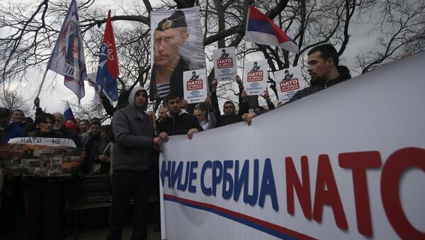 Protesters holding a banner that reads: Serbia is not NATO during a protest against NATO in downtown Belgrade, Serbia, Saturday, Feb. 20, 2016 - Sputnik Moldova-România